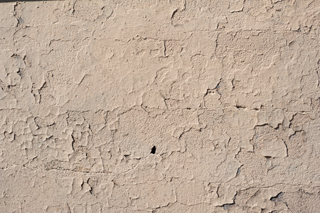 Texture of old rustic wall covered with yellow stuccoの写真素材