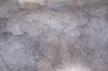 Texture of old rustic wall covered with gray stuccoの写真素材