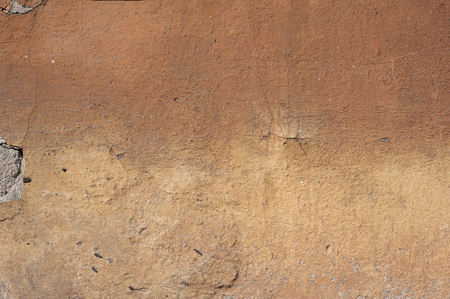 Texture of old rustic wall covered with brown stuccoの写真素材