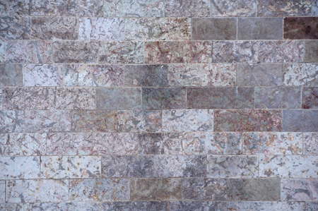 Texture of the walls of roughly processed gray square stonesの写真素材