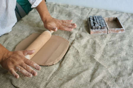 master craftsman rolls clay on tableの写真素材