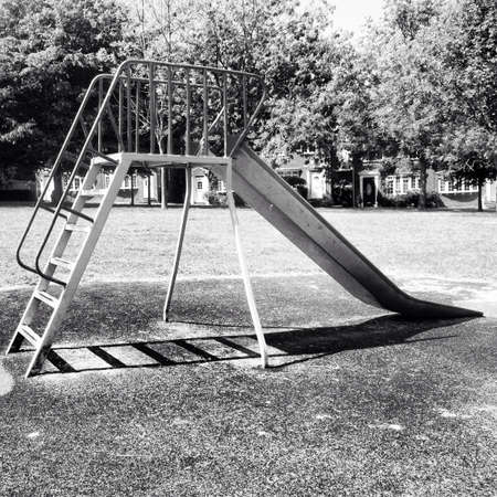 Well-used slide in a small deserted parkの素材