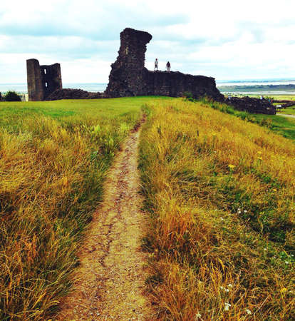 Kids standing on the ruins of a castle at hadleigh Essexの素材
