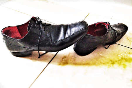 Mens work shoes stepped out of and left on hallwayの素材