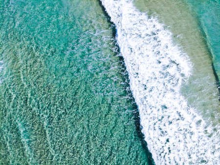 Aerial view of turquoise ocean and surf beach, Queensland, Australiaの写真素材
