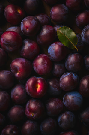 Lots of ripe plums. Background design with fresh plums.の素材