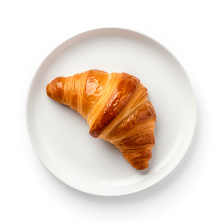 Top view of plate with croissant on white background.の素材