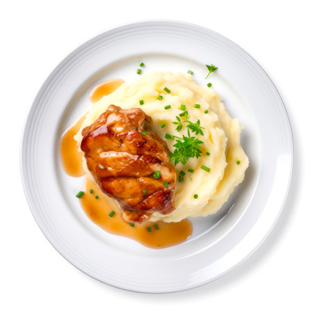 Plate of mashed potatoes with a meat chop on white background, top view.の素材
