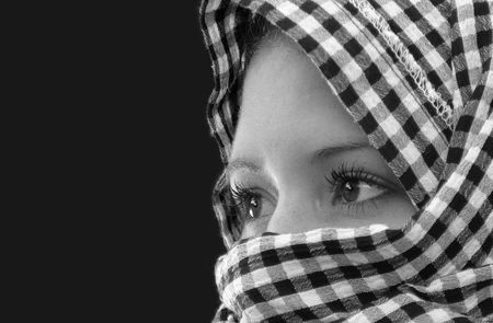 Young woman, a shawl wrapped around her head.の写真素材