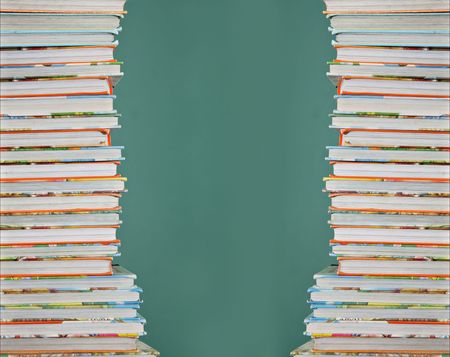 Tall stack of childrens school books.