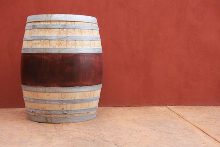 Wine barrel against a red wall. の写真素材