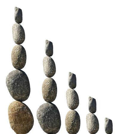 Balanced stone statues isolated on white. の写真素材