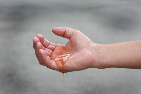 Man's hands covered in oil. Oil spill concept.の写真素材