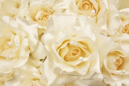White silk roses with cream pearls. Shallow dof, focus on the center blossom. の写真素材