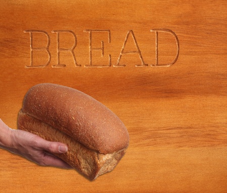 Loaf of  bread against a wooden background.の写真素材