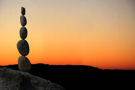 Balanced stack of stones at sunset.の写真素材
