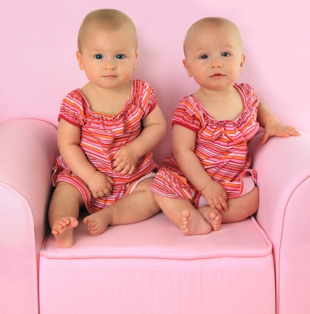 Identical twin baby girls, 10 months old  の写真素材