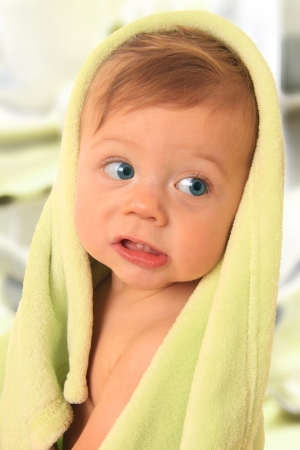 Ten month old boy, wrapped in a towel. の写真素材