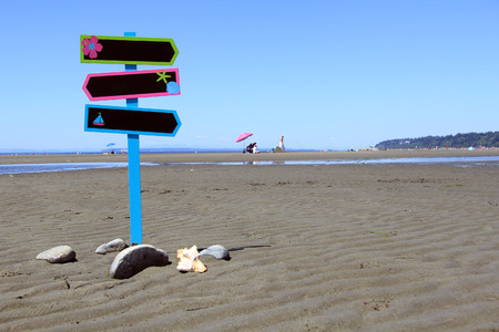 Sign post on a beach. Add your own text.