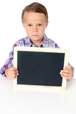 Sad five year old boy with a blank chalkboard. Add your own text.の写真素材
