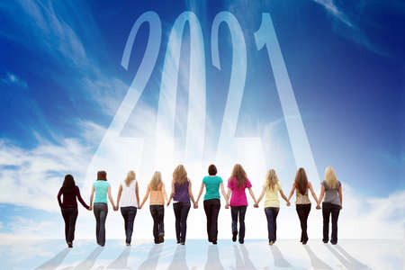 Ten young women walking hand in hand towards 2021. Happy New 2021.の写真素材