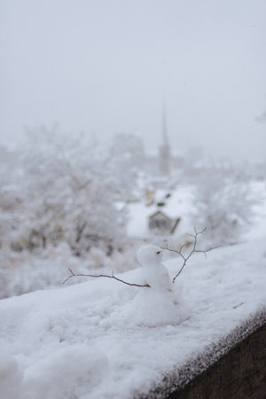 Snowman in the snow on the backgroundの写真素材