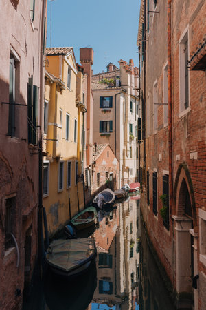 Narrow canal in Venice, Italy. Venice is one of the most popular tourist destinations in the world.の写真素材