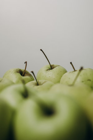 Green apples on a white background. Shallow depth of field.