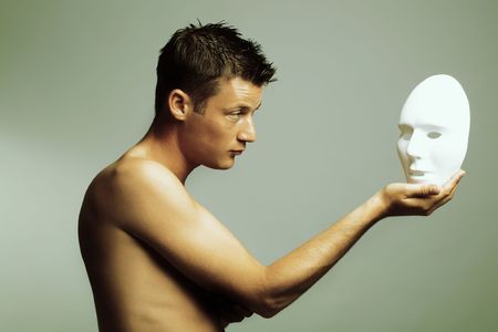 man with mask. cross-processed fashion art photo.の写真素材