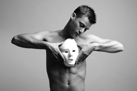 man with mask. black and white fashion art photo.の写真素材