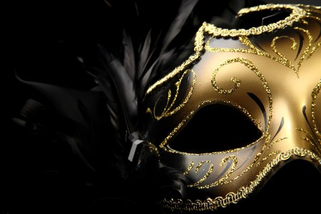 ornate carnival mask over black silk backgroundの写真素材