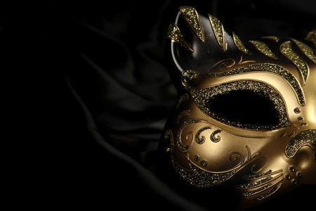 ornate carnival mask over black silk backgroundの写真素材