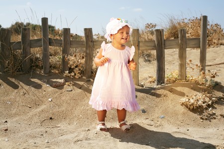 happy baby girl on the beachの写真素材