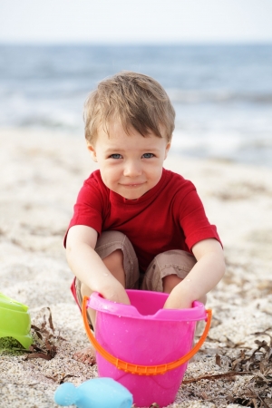 cute happy boy playing on the beachの写真素材