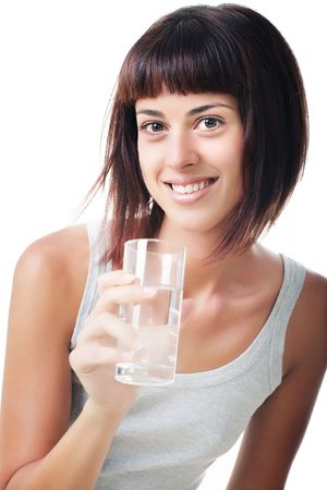 Beautiful smiling young woman holding a glass of waterの写真素材
