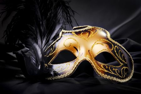 Carnival mask on black silk backgroundの写真素材