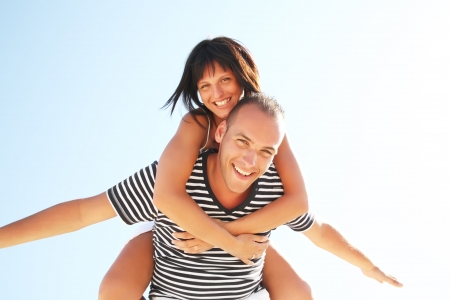 Smiling young couple having fun at the beachの写真素材