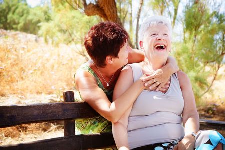 Beautiful senior mother and daughter having funの写真素材