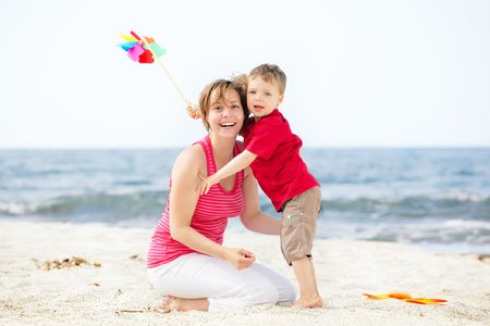 Mother and son having fun on the beach.の写真素材