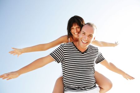 Portrait of a happy young couple having fun outdoors. の写真素材