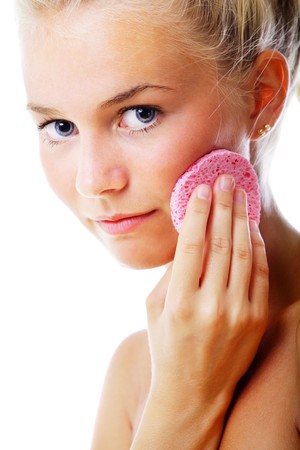 Beautiful woman removing make-up. Isolated over white.の写真素材