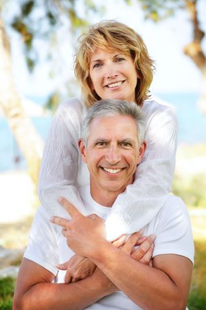 Close-up portrait of a mature couple smiling and embracing.の写真素材