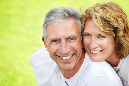 Close-up portrait of a mature couple smiling and embracing.の写真素材