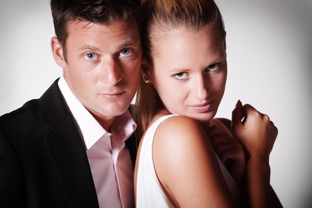 Attractive young couple. Studio portrait on grey background.の写真素材