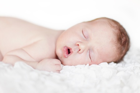 Newborn baby sleeping. Soft focus, shallow DoF.の写真素材