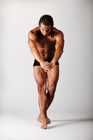 young male dancer posing over grey backgroundの写真素材