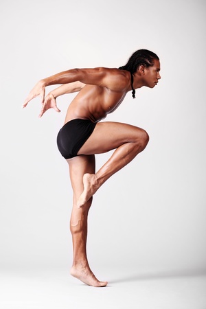young male dancer posing over grey backgroundの写真素材