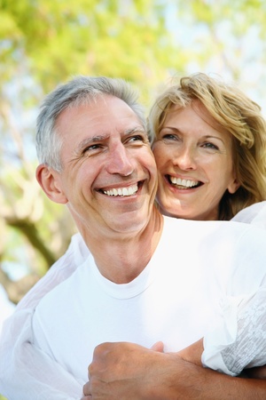 Mature couple smiling and embracingの写真素材