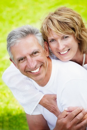 Mature couple smiling and embracingの写真素材