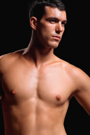 Healthy muscular young man  Isolated on black background   Shallow DoF with focus on chest and neck の写真素材